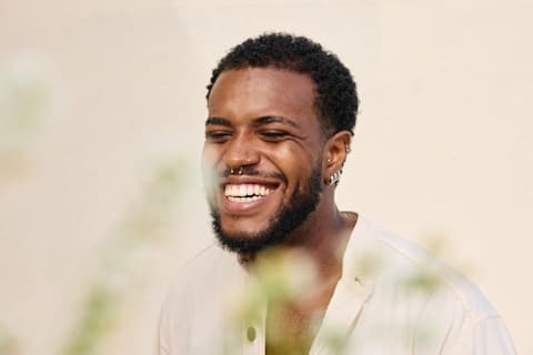 A man in a white shirt, smiling